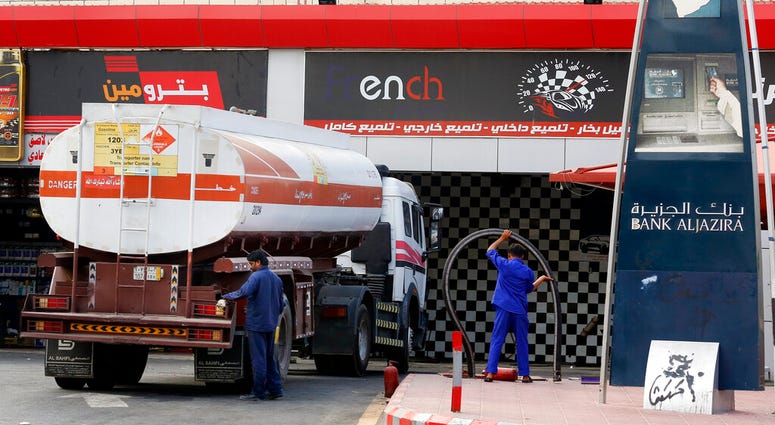 Workers refuel the tank at a gas station in Jiddah, Saudi Arabia, Tuesday, Sept. 17, 2019. U.S. President Donald Trump declared Monday that it "looks" like Iran was behind the explosive attack on Saudi Arabian oil facilities.