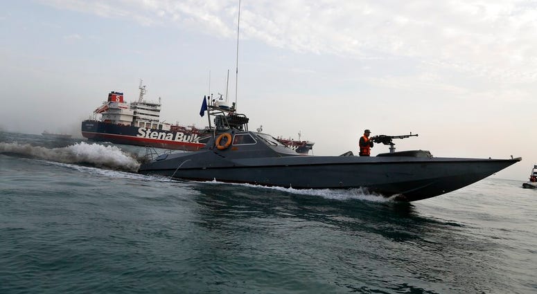 In this July 21, 2019 file photo, a speedboat of the Iran's Revolutionary Guard moves around a British-flagged oil tanker Stena Impero. (Hasan Shirvani/Mizan News Agency via AP, File)