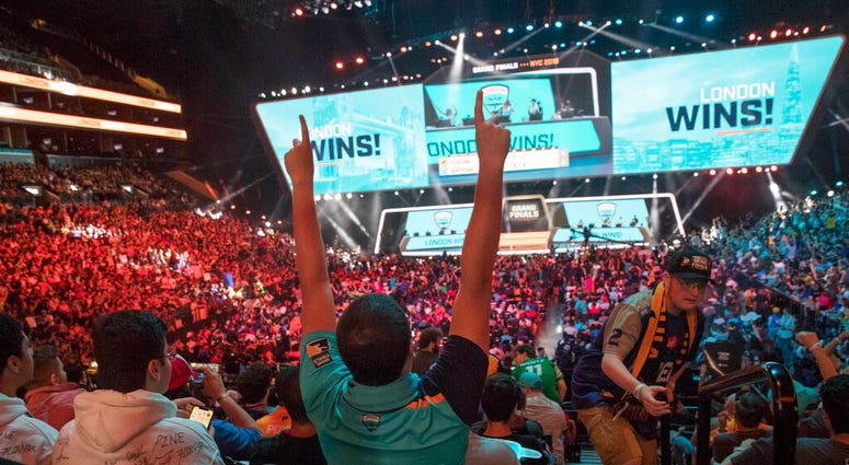 FILE - In this July 28, 2018, file photo, London Spitfire fan Rick Ybarra, of Plainfield, Ind., reacts after London won the second game against the Philadelphia Fusion during the Overwatch League Grand Finals competition at Barclays Center in New York.
