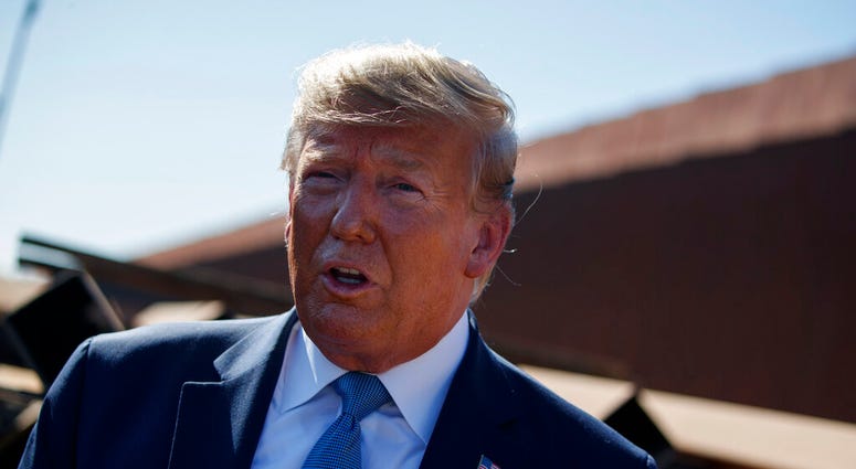 President Donald Trump talks with reporters after touring a section of the southern border wall, Wednesday, Sept. 18, 2019, in Otay Mesa, Calif.