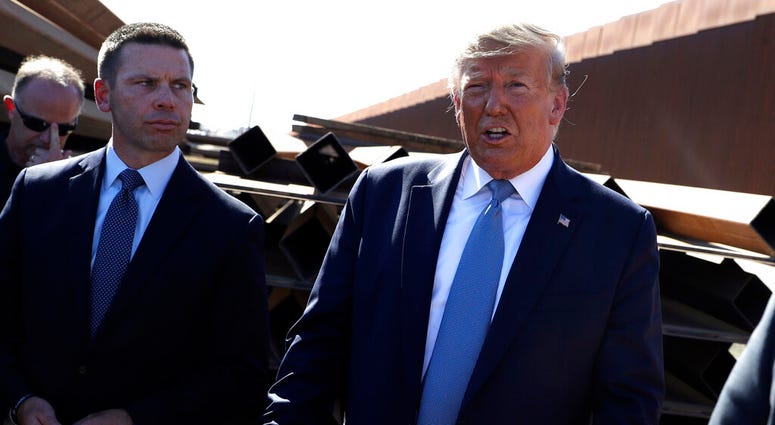 In this sept. 18, 2019, photo, President Donald Trump talks with reporters as he tours a section of the southern border wall. (AP Photo/Evan Vucci)