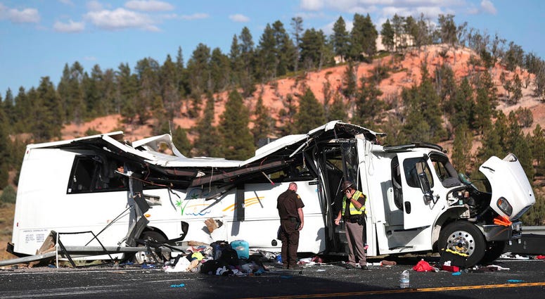 Authorities work the scene where at least four people were killed in a tour bus crash near Bryce Canyon National Park, Friday, Sept. 20, 2019, in Utah.