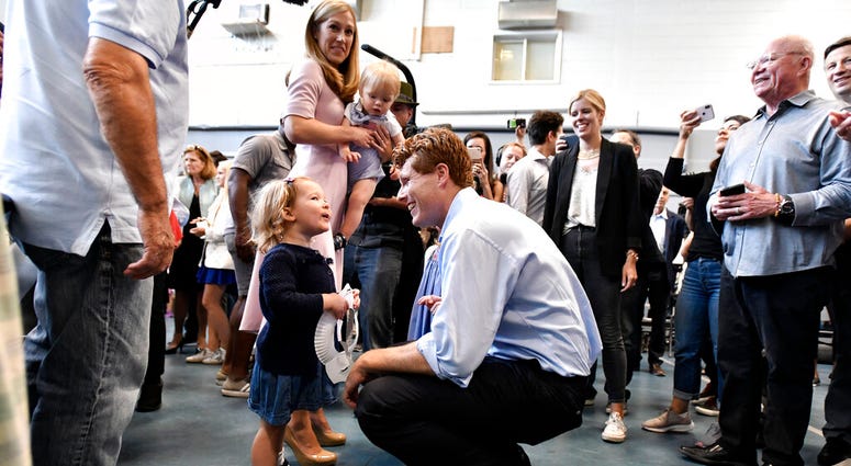 Democratic U.S. Rep. Joseph Kennedy III, D-Mass., speaks to a young supporter as he arrives with his wife Lauren Kennedy, and son James Kennedy, 1, in East Boston to announce his candidacy for the Senate on Saturday, Sept. 21, 2019, in Boston.