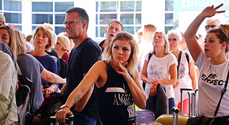 British passengers with Thomas Cook wait in queue at Antalya airport in Antalya, Turkey, Monday Sept. 23, 2019.