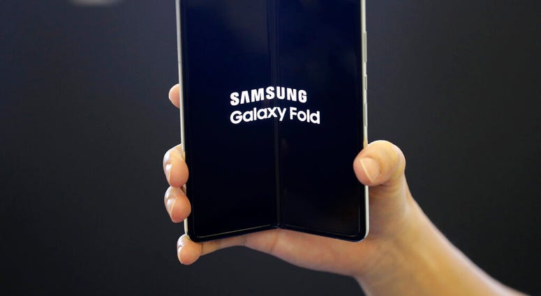 FILE - In this Sept. 6, 2019, file photo an employee holds the Samsung Electronics Co.'s Galaxy Fold for a photograph at a shopping mall in Seoul, South Korea. (AP Photo/Lee Jin-man, File) FILE - In this Sept. 6, 2019, file photo an employee holds the Samsung Electronics Co.'s Galaxy Fold for a photograph at a shopping mall in Seoul, South Korea. (AP Photo/Lee Jin-man, File)