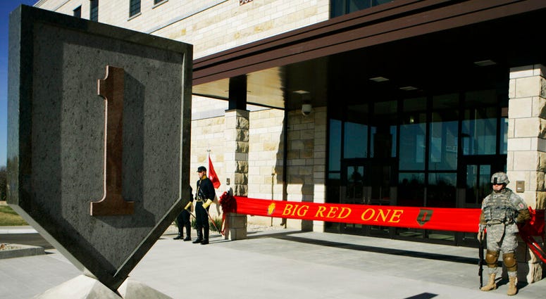 FILE - In this Feb. 9, 2015 file photo, an honor guard stands at the entrance before ribbon cutting ceremonies for the new 1st Infantry Division Headquarters at Fort Riley, Kan.