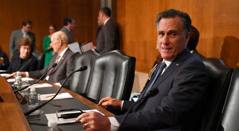 Sen. Mitt Romney, R-Utah, talks with a colleague during a break in an executive session of the Senate Health, Education, Labor and Pensions Committee on Capitol Hill in Washington, Tuesday, Sept. 24, 2019. (AP Photo/Susan Walsh)