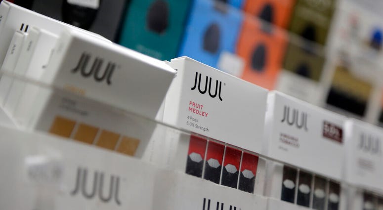 FILE - In this Dec. 20, 2018, file photo Juul products are displayed at a smoke shop in New York. Philip Morris and Altria have ended merger talks and JUUL’s CEO is stepping down from the top post as criticism over vaping continues to intensify.