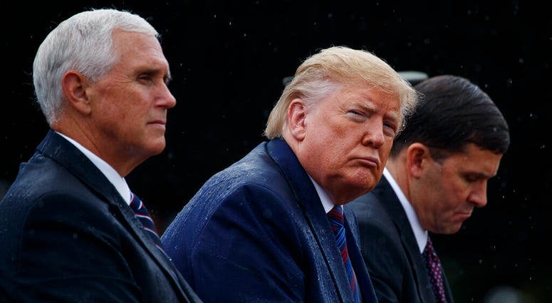 From left, Vice President Mike Pence, President Donald Trump, and Defense Secretary Mark Esper, participate in an Armed Forces welcome ceremony for the new chairman of the Joint Chiefs of Staff, Gen. Mark Milley, Monday, Sept. 30, 2019, at Joint Base Myer