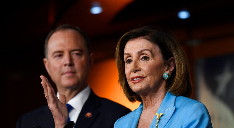 House Speaker Nancy Pelosi of Calif., joined by House Intelligence Committee Chairman Rep. Adam Schiff, D-Calif., speaks during a news conference on Capitol Hill in Washington, Wednesday, Oct. 2, 2019 (AP Photo/Susan Walsh)