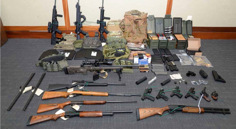 This file image provided by the Maryland U.S. District Attorney's Office shows a photo of firearms and ammunition that was in the motion for detention pending trial in the case against Christopher Paul Hasson. (Maryland U.S. District Attorney's Office)