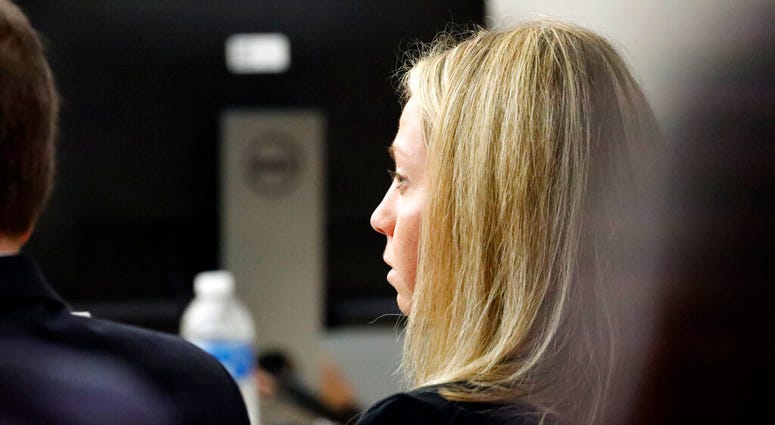 Fired Dallas police officer Amber Guyger listens as friends, family and coworkers speak in her defense during the sentencing phase of her murder trial, Wednesday, Oct. 2, 2019, in Dallas.