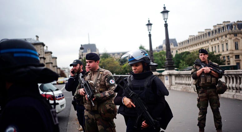 Armed police officers and soldiers patrol after an incident at the police headquarters after in Paris, Thursday, Oct. 3, 2019. (AP Photo/Kamil Zihnioglu)