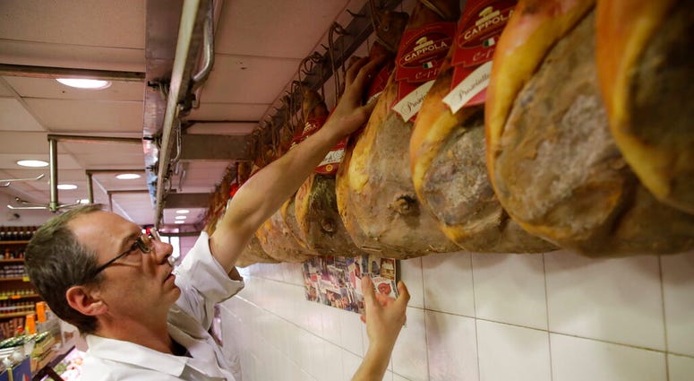 Italian ham is put on display in a deli in Rome, Thursday, Oct. 3, 2019. The U.S. had prepared for Wednesday's ruling and already drawn up lists of the dozens of goods it would put tariffs on.