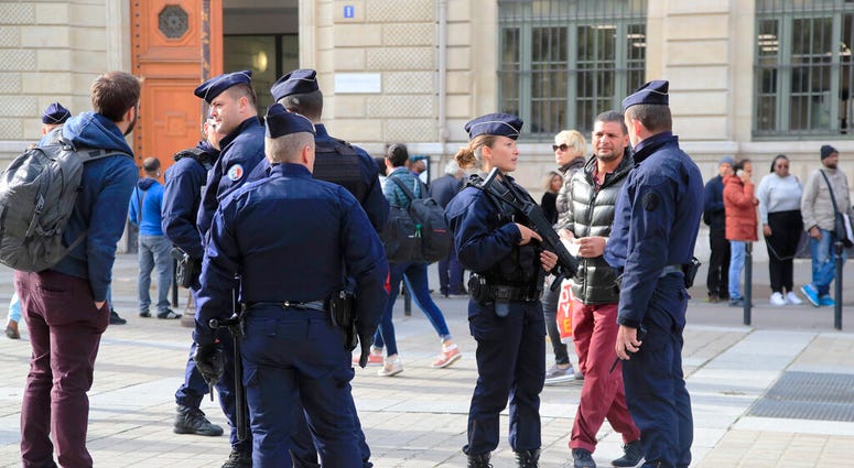 Police officers patrol outside the police headquarters in Paris, Friday, Oct. 4, 2019. (AP Photo/Michel Euler)