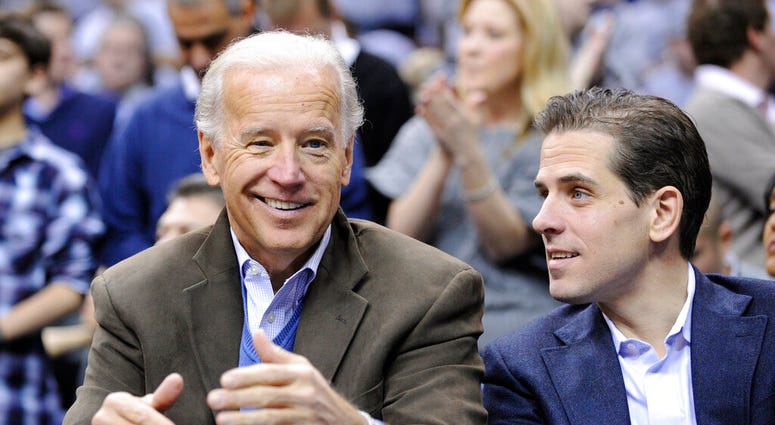 In this Jan. 30, 2010, file photo, Vice President Joe Biden, left, with his son Hunter, right, at the Duke Georgetown NCAA college basketball game in Washington. (AP Photo/Nick Wass, File)
