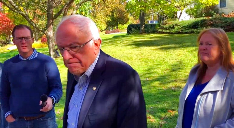 Democratic presidential candidate Sen. Bernie Sanders, I-Vt., speaks we reporters outside his home, Tuesday, Oct. 8, 2019, in Burlington, Vt. (AP Photo/Wilson Ring)
