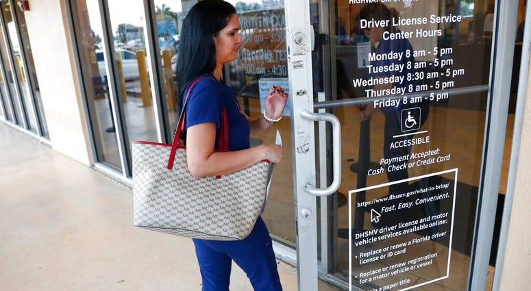 A woman enters a Florida Highway Safety and Motor Vehicles drivers license service center, Tuesday, Oct. 8, 2019, in Hialeah, Fla. (AP Photo/Wilfredo Lee) A woman enters a Florida Highway Safety and Motor Vehicles drivers license service center, Tuesday, Oct. 8, 2019, in Hialeah, Fla. (AP Photo/Wilfredo Lee)