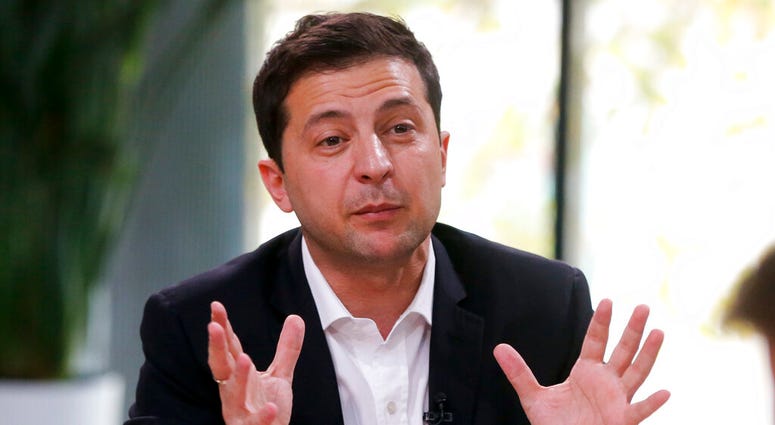 Ukrainian President Volodymyr Zelenskiy speaks during talks with journalists in Kyiv, Ukraine, Thursday, Oct. 10, 2019. (AP Photo/Efrem Lukatsky)