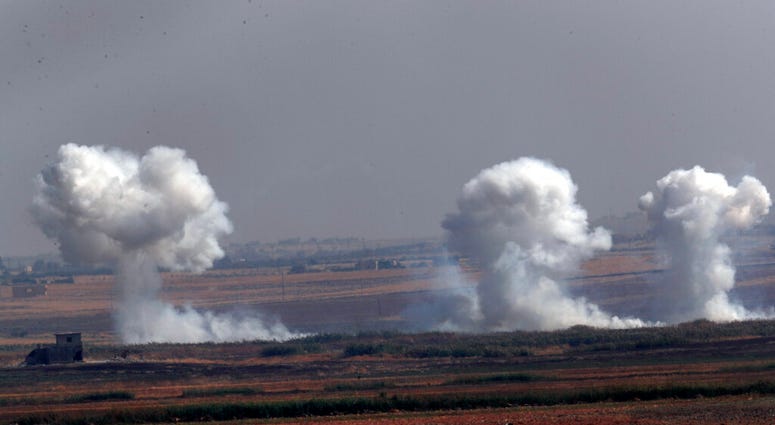 Smoke billows from targets inside Syria during bombardment by Turkish forces Thursday, Oct. 10, 2019. (AP Photo/Lefteris Pitarakis)