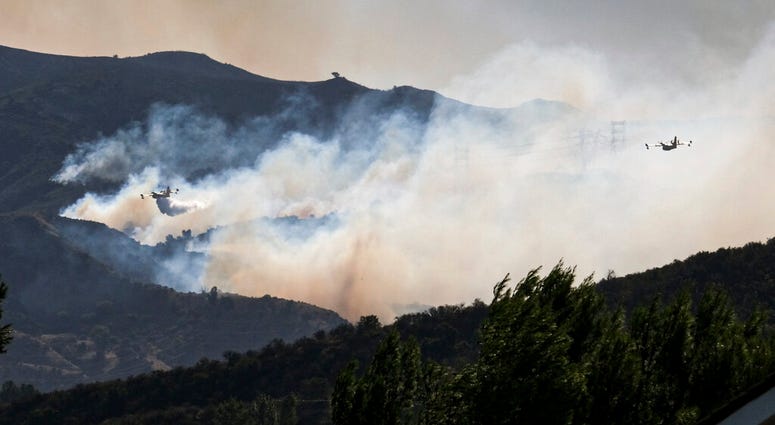 Super scoopers make drops on the Saddleridge fire in Placerita Canyon near Newhall, Calif., Friday, Oct. 11, 2019. (David Crane/The Orange County Register via AP)