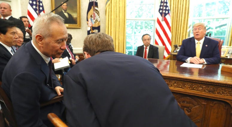 President Donald Trump watches as Chinese Vice Premier Liu He speaks to U.S. Trade representative Robert Lighthizer, right, in the Oval Office of the White House in Washington, Friday, Oct. 11, 2019.