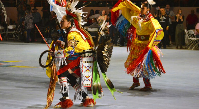 FILE - In this April 27, 2019 file photo, dancers enter at the Gathering of Nations, one of the world's largest gatherings of indigenous people in Albuquerque, N.M. (AP Photo/Russell Contreras, File) FILE - In this April 27, 2019 file photo, dancers enter at the Gathering of Nations, one of the world's largest gatherings of indigenous people in Albuquerque, N.M. (AP Photo/Russell Contreras, File)
