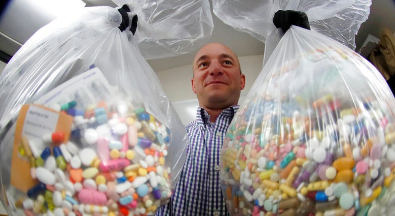 FILE - Narcotics detective Ben Hill, with the Barberton Police Department, shows two bags of medications that are are stored in their headquarters and slated for destruction in Barberton, Ohio. (AP Photo/Keith Srakocic, File) FILE - Narcotics detective Ben Hill, with the Barberton Police Department, shows two bags of medications that are are stored in their headquarters and slated for destruction in Barberton, Ohio. (AP Photo/Keith Srakocic, File)