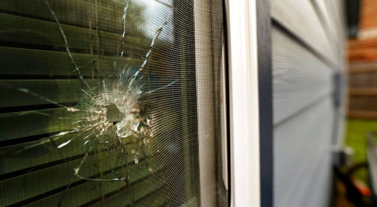 A bullet hole from the police officer's shot is seen in the rear window of Atatiana Jefferson's home on E. Allen Ave in Fort Worth, Texas, Tuesday, Oct. 15, 2019.(Tom Fox/The Dallas Morning News via AP)