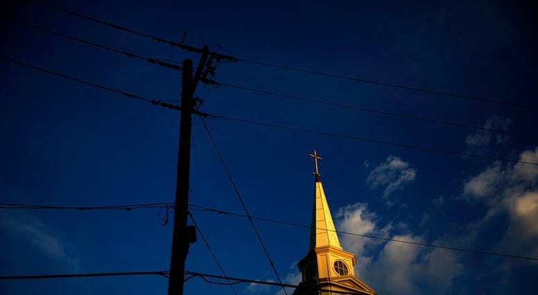 In this Tuesday, April 11, 2017 file photo, the sun sets on a Baptist church in Georgia. (AP Photo/David Goldman)
