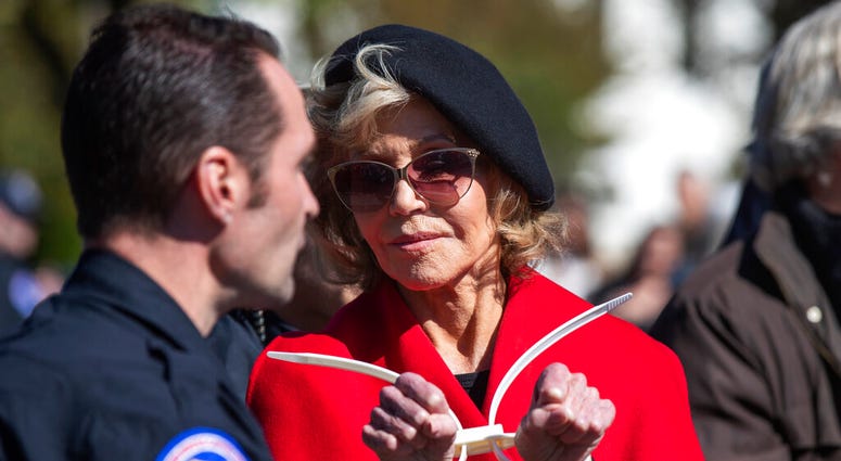 Actress Jane Fonda gestures after being arrested during a rally on Capitol Hill in Washington, Friday, Oct. 18, 2019. (AP Photo/Manuel Balce Ceneta)