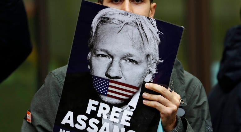 Supporters of Wikileaks founder Julian Assange demonstrate outside Westminster Magistrates' Court in London where Assange is expected to appear as he fights extradition to the United States. (AP Photo/Kirsty Wigglesworth) Supporters of Wikileaks founder Julian Assange demonstrate outside Westminster Magistrates' Court in London where Assange is expected to appear as he fights extradition to the United States. (AP Photo/Kirsty Wigglesworth)