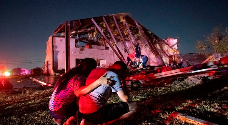 In this Sunday, Oct. 20, 2019 photo, Henry Ramirez, a member of Primera Iglesia Dallas, is consoled by his mother Maribel Morales as they survey severe damage to the church. (AP Photo/Jeffrey McWhorter) In this Sunday, Oct. 20, 2019 photo, Henry Ramirez, a member of Primera Iglesia Dallas, is consoled by his mother Maribel Morales as they survey severe damage to the church. (AP Photo/Jeffrey McWhorter)