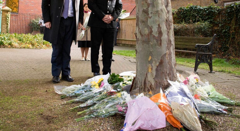 Britain's Prime Minister Boris Johnson stands with the Chief Constable of Essex Police, Ben-Julian Harrington after laying flowers during a visit to Thurrock Council Offices, England. (Stefan Rousseau/Pool via AP) Britain's Prime Minister Boris Johnson stands with the Chief Constable of Essex Police, Ben-Julian Harrington after laying flowers during a visit to Thurrock Council Offices, England. (Stefan Rousseau/Pool via AP)