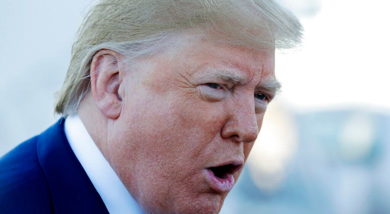 President Donald Trump talks to reporters before boarding Air Force One for a trip to Chicago to attend the International Association of Chiefs of Police Annual Conference and Exposition, Monday, Oct. 28, 2019. (AP Photo/Evan Vucci)