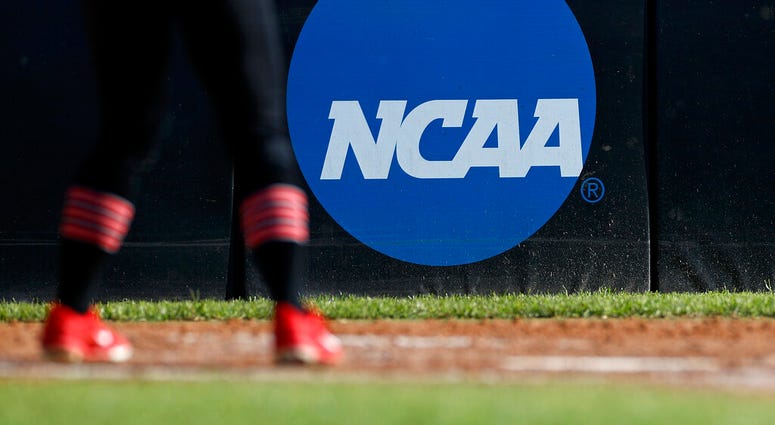 FILE - In this April 19, 2019, file photo, an athlete stands near a NCAA logo during a softball game in Beaumont, Texas.