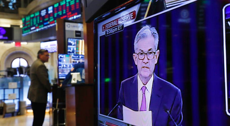 In this June 19, 2019, file photo the Washington news conference of Federal Reserve Chair Jerome Powell appears on television screen on the trading floor of the New York Stock Exchange shows the rate decision of the Federal Reserve. AP Photo/Richard Drew)