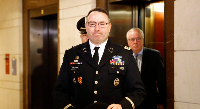 Army Lieutenant Colonel Alexander Vindman, a military officer at the National Security Council, center, arrives on Capitol Hill in Washington, Tuesday, Oct. 29, 2019