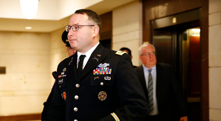 Army Lieutenant Colonel Alexander Vindman, a military officer at the National Security Council, center, arrives on Capitol Hill in Washington, Tuesday, Oct. 29, 2019. (AP Photo/Patrick Semansky)