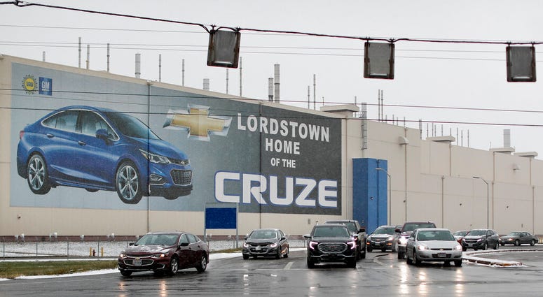 In this Nov. 27, 2018, file photo a banner depicting the Chevrolet Cruze model vehicle is displayed at the General Motors' Lordstown plant in Lordstown, Ohio. (AP Photo/John Minchillo, File)