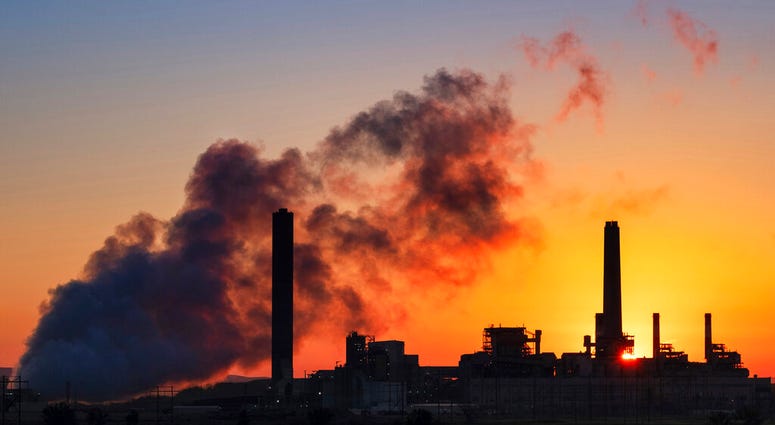 In this July 27, 2018 photo, the Dave Johnson coal-fired power plant is silhouetted against the morning sun in Glenrock, Wyo. (AP Photo/J. David Ake)