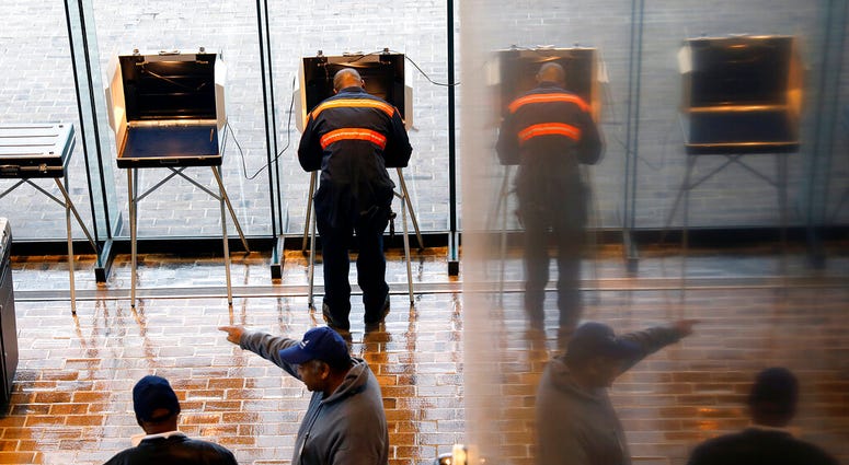 In this Nov. 5, 2019, file photo, voters cast their ballots at Hampton City Hall, in Hampton, Va. (Jonathon Gruenke/The Virginian-Pilot via AP, File)