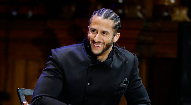 FILE - In this Oct. 11, 2018, file photo, former NFL football quarterback Colin Kaepernick smiles on stage during W.E.B. Du Bois Medal ceremonies at Harvard University, in Cambridge, Mass. (AP Photo/Steven Senne, File) FILE - In this Oct. 11, 2018, file photo, former NFL football quarterback Colin Kaepernick smiles on stage during W.E.B. Du Bois Medal ceremonies at Harvard University, in Cambridge, Mass. (AP Photo/Steven Senne, File)