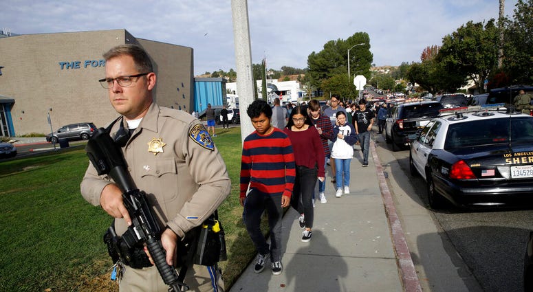 This Nov. 14, 2019 file photo shows students being escorted out of Saugus High School after a shooting on the campus in Santa Clarita, Calif. (AP Photo/Marcio Jose Sanchez, File) This Nov. 14, 2019 file photo shows students being escorted out of Saugus High School after a shooting on the campus in Santa Clarita, Calif. (AP Photo/Marcio Jose Sanchez, File)