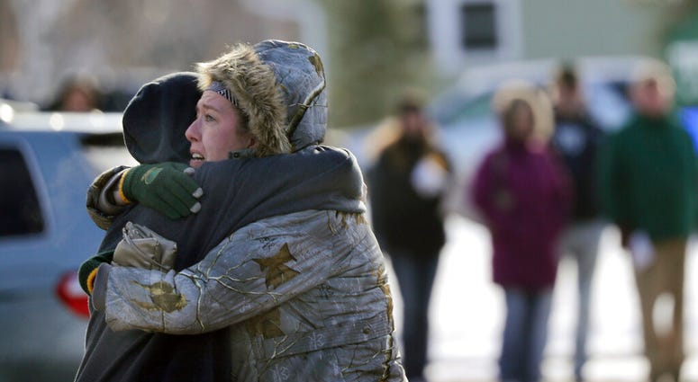 Sarah Rogstad, right, hugs Morgan Rogstad, grade 9, after being reunited at the Tipler Middle school reunification center on Tuesday December 3, 2019, in Oshkosh, Wis. (Wm. Glasheen/The Post-Crescent via AP) Sarah Rogstad, right, hugs Morgan Rogstad, grade 9, after being reunited at the Tipler Middle school reunification center on Tuesday December 3, 2019, in Oshkosh, Wis. (Wm. Glasheen/The Post-Crescent via AP)