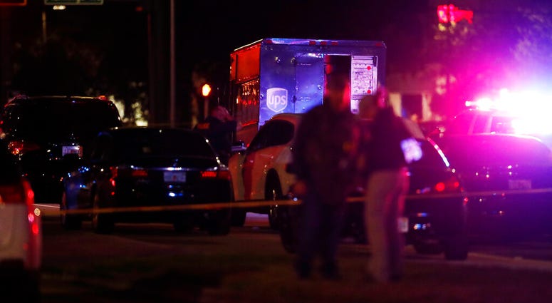 Authorities investigate the scene of a shooting Thursday, Dec. 5, 2019, in Miramar, Fla. Four people, including a UPS driver, were killed Thursday after robbers stole the driver’s truck and led police on a chase that ended in gunfire at a busy Florida int