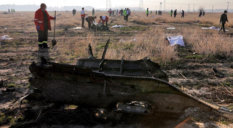 In this Wednesday, Jan. 8, 2020 photo, rescue workers search the scene where a Ukrainian plane crashed in Shahedshahr, southwest of the capital Tehran, Iran.