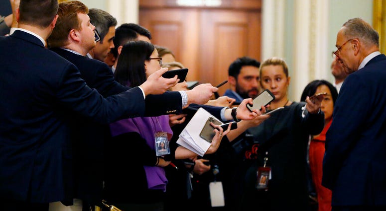 Reporters extend recording devices to Senate Minority Leader Chuck Schumer, D-N.Y., as he talks at the Capitol in Washington, Tuesday, Jan. 21, 2020. (AP Photo/Julio Cortez) Reporters extend recording devices to Senate Minority Leader Chuck Schumer, D-N.Y., as he talks at the Capitol in Washington, Tuesday, Jan. 21, 2020. (AP Photo/Julio Cortez)