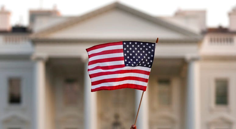 In this Sept. 2017 file photo, a flag is waved outside the White House, in Washington. (AP Photo/Carolyn Kaster) In this Sept. 2017 file photo, a flag is waved outside the White House, in Washington. (AP Photo/Carolyn Kaster)