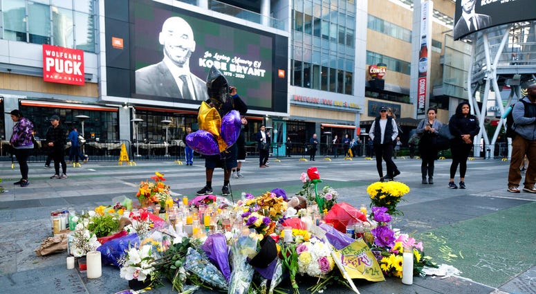 Flowers and candles are placed at a memorial for Kobe Bryant near Staples Center Monday, Jan. 27, 2020, in Los Angeles. (AP Photo/Ringo H.W. Chiu) Flowers and candles are placed at a memorial for Kobe Bryant near Staples Center Monday, Jan. 27, 2020, in Los Angeles. (AP Photo/Ringo H.W. Chiu)